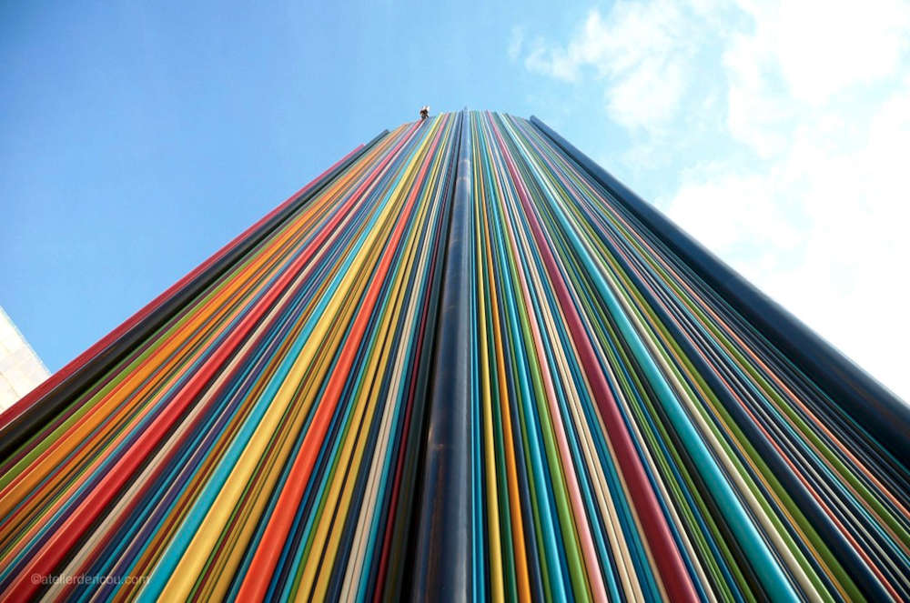 A multicoloured, striated chimney juts into the sky of La Defénse