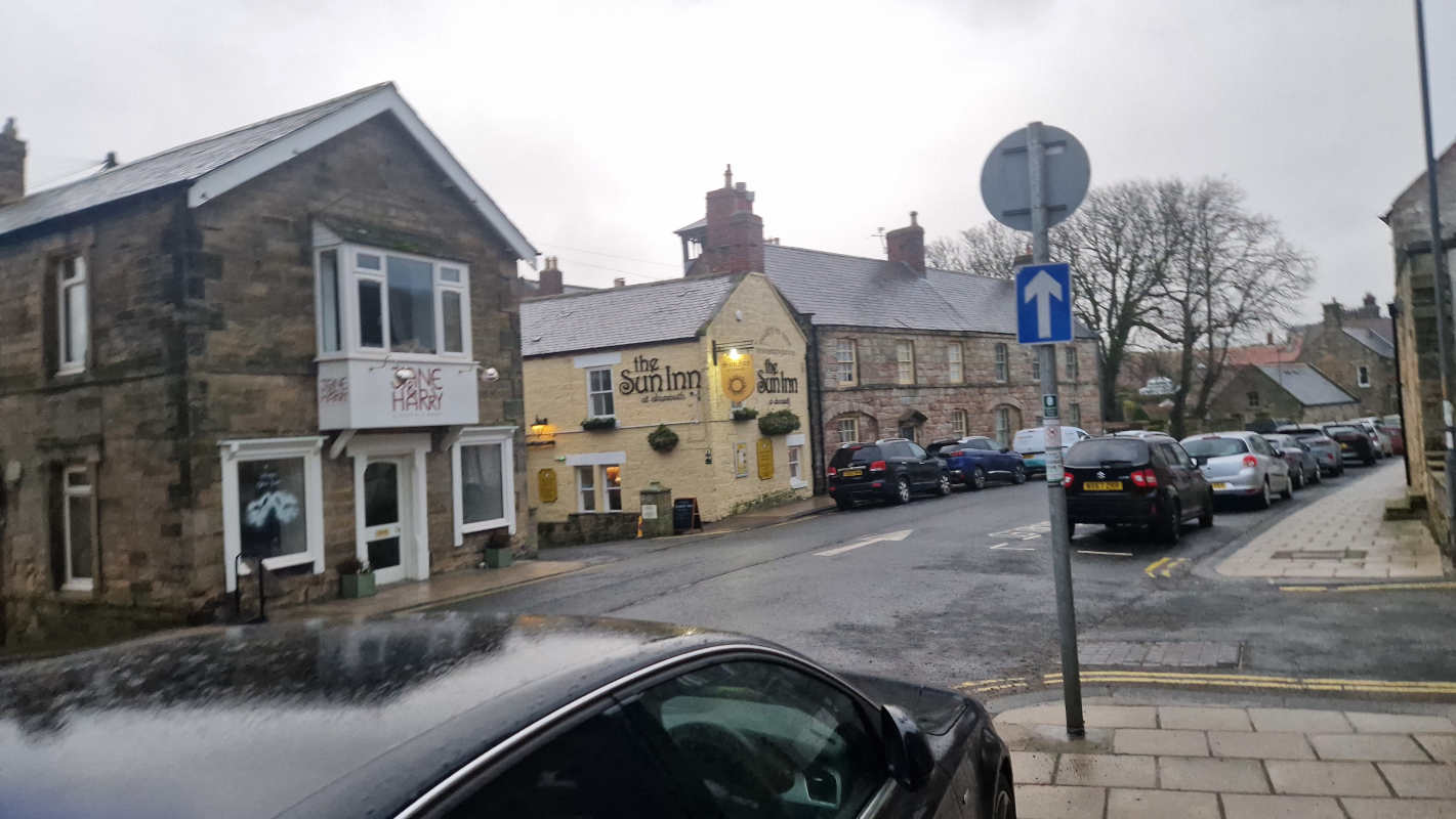 A typical small-town Northumberland street scene, with a pub named ‘The Sun Inn’ at centre
